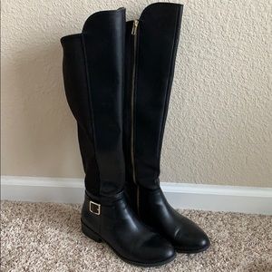 Tall black riding boots.
